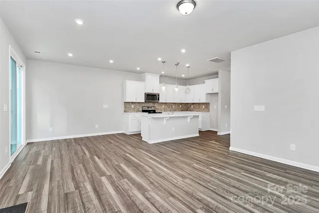 a view of kitchen with wooden floor
