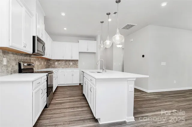 a kitchen with a sink stove and cabinets