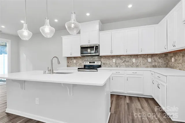 a kitchen with cabinets appliances and a sink