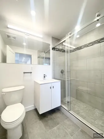 a bathroom with a toilet sink and shower