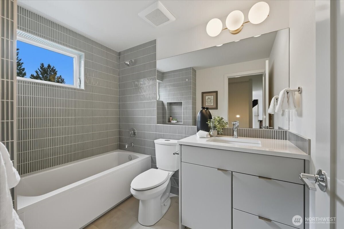 13047 39th Avenue Northeast, Unit A Seattle, WA 98125 - Photo 11 of 23 a bathroom with a sink a toilet and bathtub