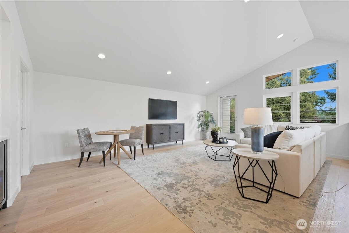 13047 39th Avenue Northeast, Unit A Seattle, WA 98125 - Photo 12 of 23 a living room with furniture a flat screen tv and a table