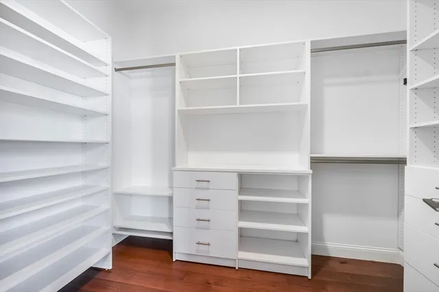 a view of walk in closet with empty racks