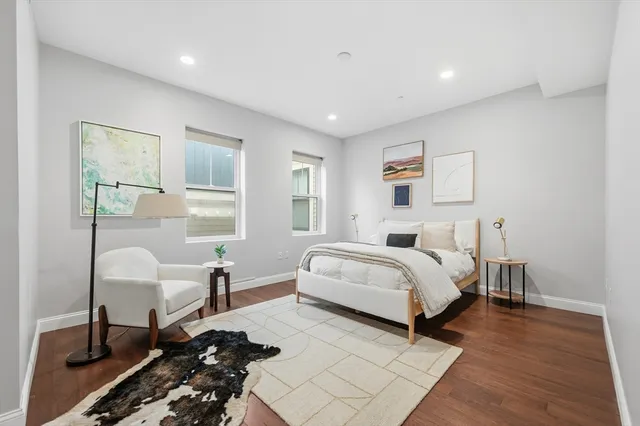 a spacious bedroom with a bed and a window