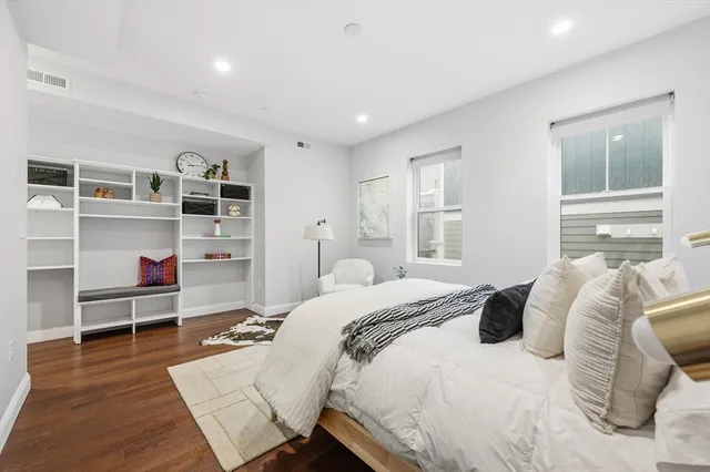a bedroom with a bed closet and a window