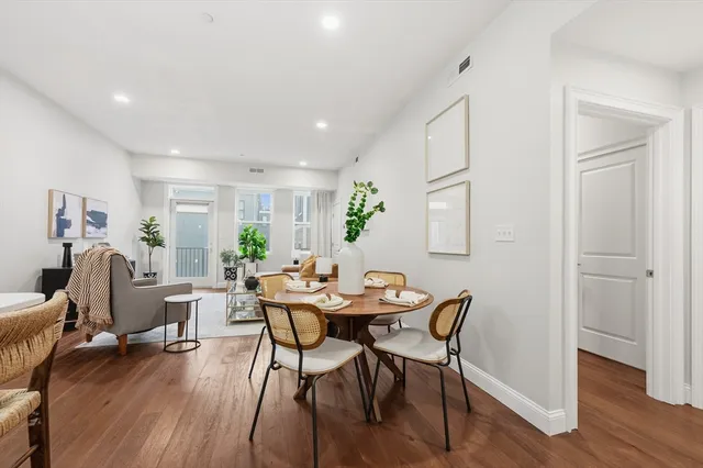 a view of a dining room with furniture and wooden floor