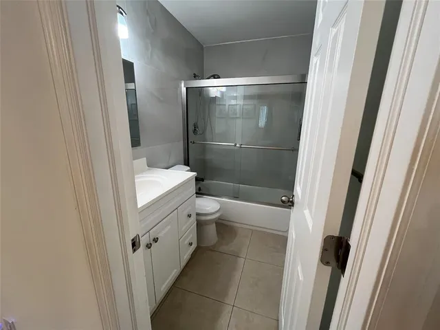 a bathroom with a double vanity sink toilet and shower
