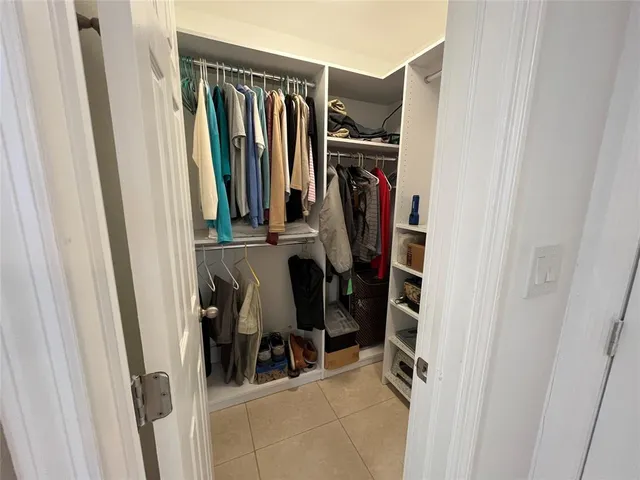 a view of walk in closet with clothes