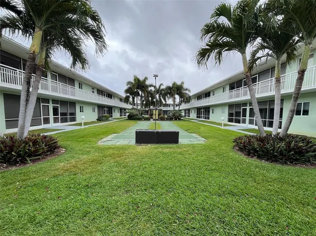 a view of a house with a swimming pool and sitting area
