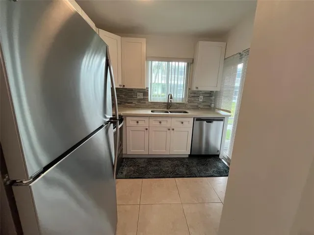a kitchen with stainless steel appliances a sink stove and refrigerator