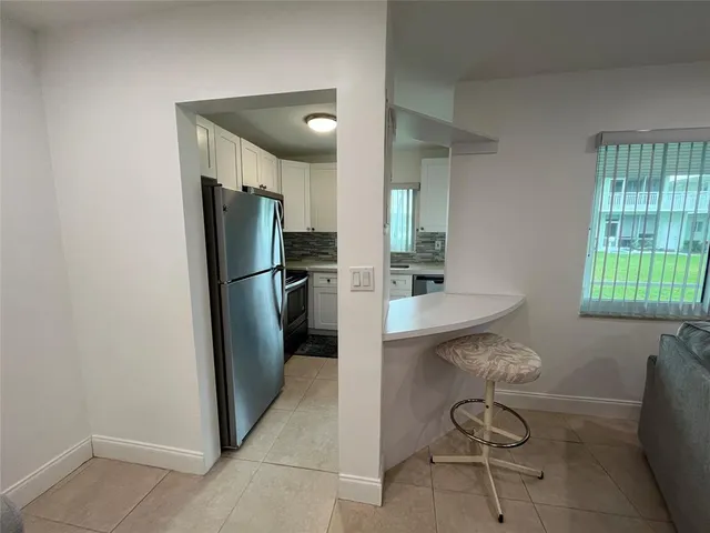 a kitchen with stainless steel appliances a refrigerator and a sink