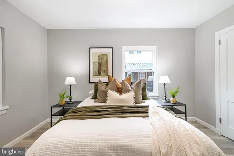 a bedroom with a bed lamp and window