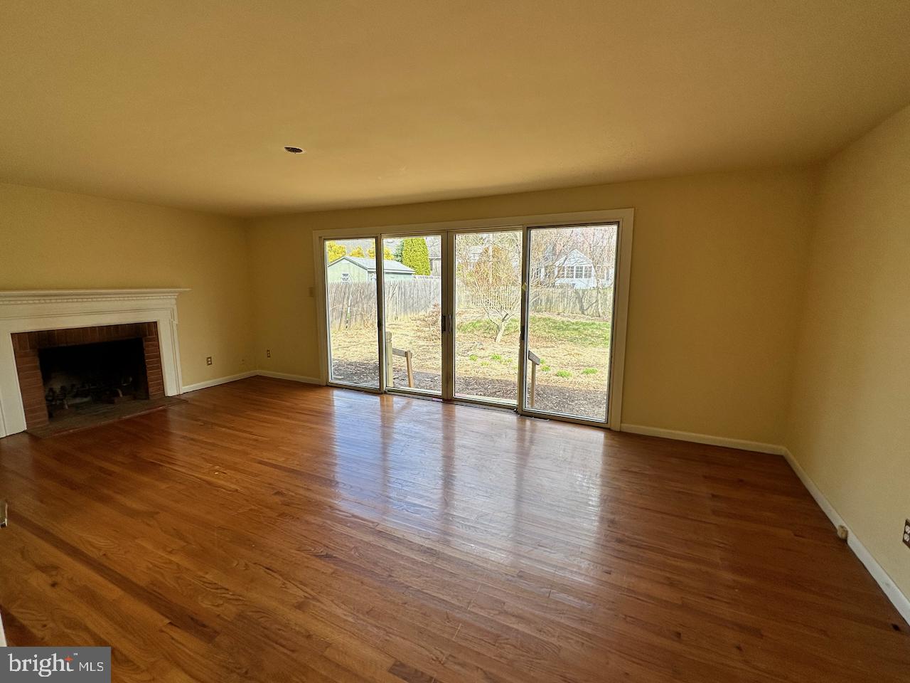 61 Devon Road Paoli, PA 19301 - Photo 11 of 25 a view of an empty room with wooden floor and a window