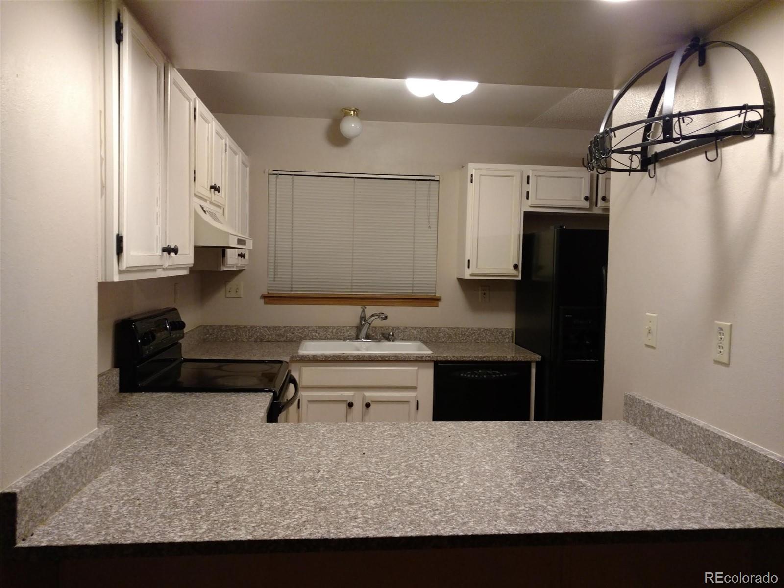 8901 Bermuda Run Circle Highlands Ranch, CO 80130 - Photo 2 of 17 a living room with stainless steel appliances kitchen island granite countertop furniture and a refrigerator