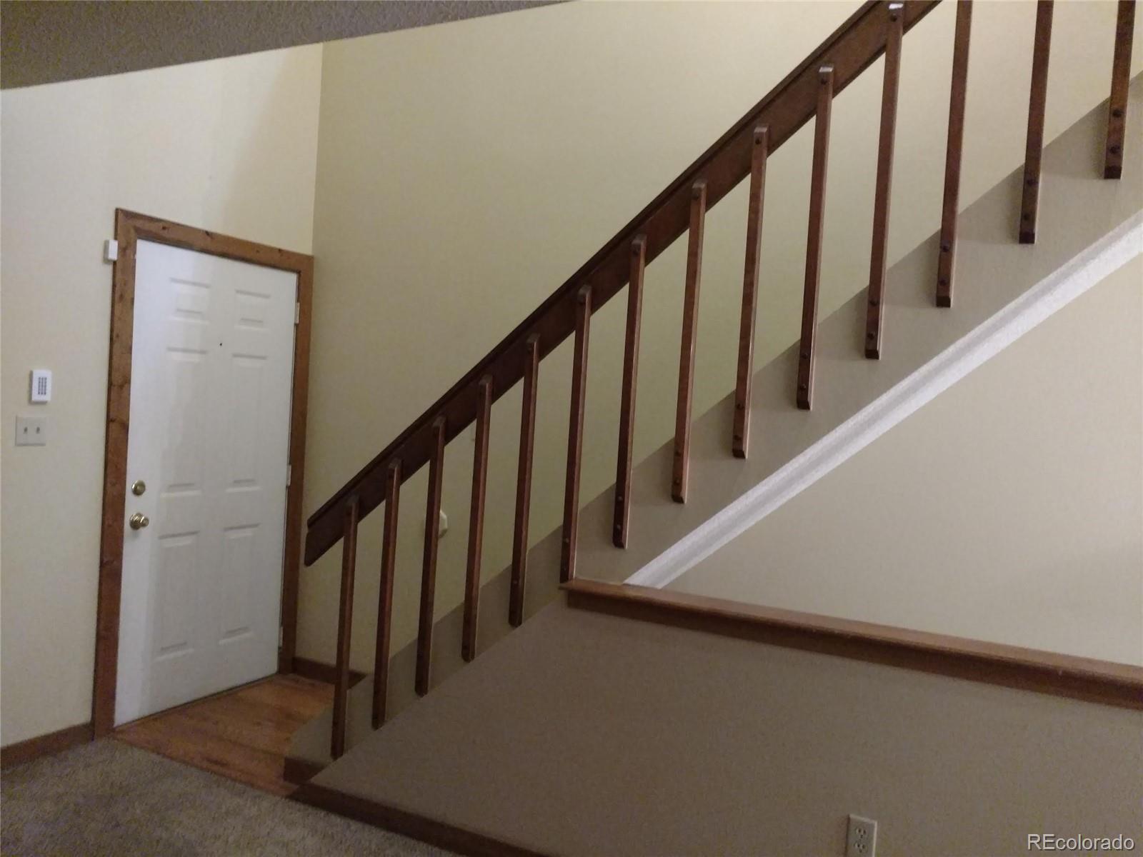 8901 Bermuda Run Circle Highlands Ranch, CO 80130 - Photo 7 of 17 a view of staircase with lots of frames on wall