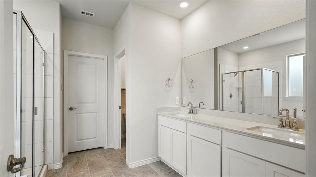 4191 Waldron Trail Forney, TX 75126 - Photo 13 of 20 Bathroom featuring a dual vanity with white cabinetry, light-toned countertops, and brushed nickel fixtures