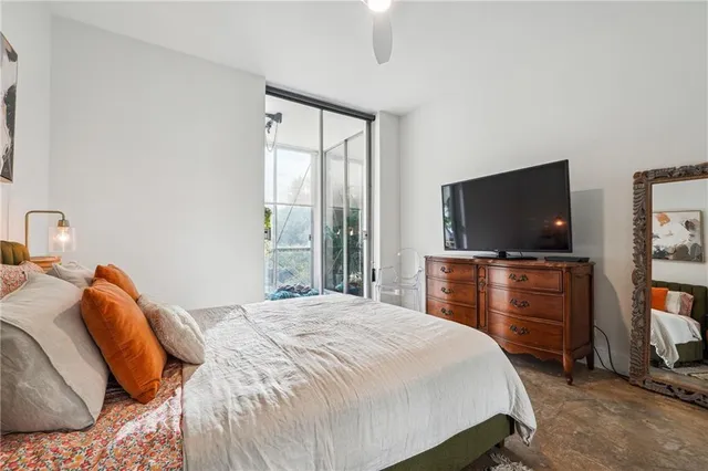 a bedroom with a bed and a flat screen tv