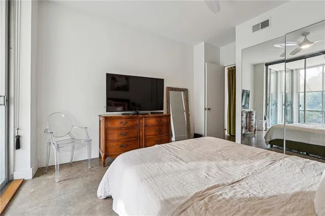 a bedroom with a bed and a painting on the wall