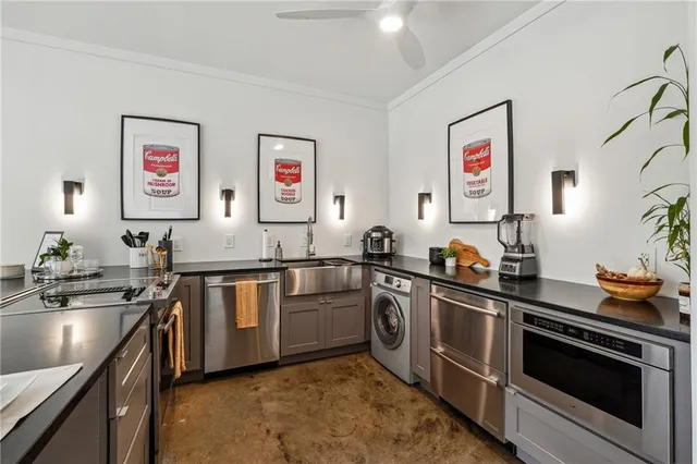 a kitchen with stainless steel appliances granite countertop a sink stove and refrigerator