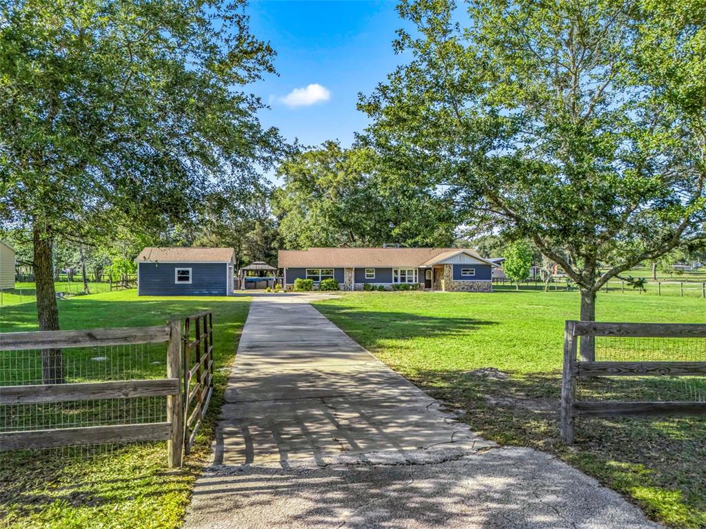 2405 Southeast 157th Lane Road Summerfield, FL 34491 - Photo 1 of 35 a front view of a house with a yard