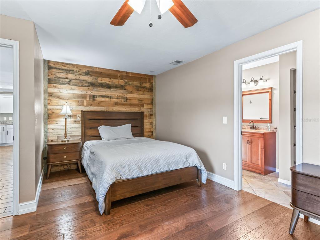 2405 Southeast 157th Lane Road Summerfield, FL 34491 - Photo 20 of 35 a bedroom with a bed and wooden floor