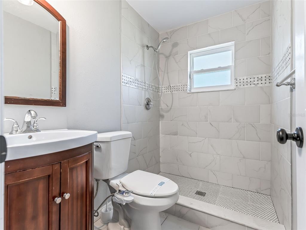 2405 Southeast 157th Lane Road Summerfield, FL 34491 - Photo 24 of 35 a bathroom with a sink toilet and shower