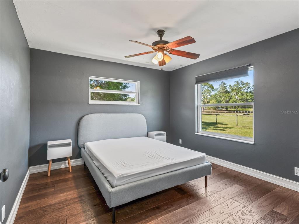 2405 Southeast 157th Lane Road Summerfield, FL 34491 - Photo 25 of 35 a bedroom with a bed and a chandelier