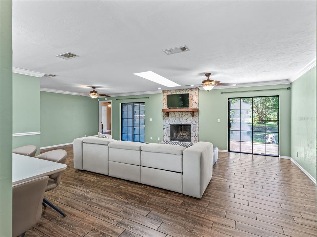 2405 Southeast 157th Lane Road Summerfield, FL 34491 - Photo 7 of 35 a living room with furniture and a fireplace
