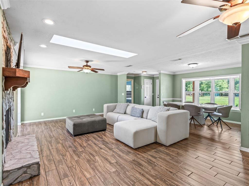 2405 Southeast 157th Lane Road Summerfield, FL 34491 - Photo 10 of 35 a living room with furniture and a wooden floor
