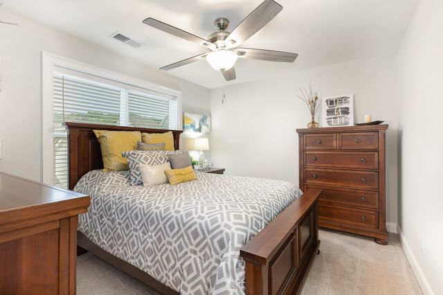 a bedroom with a bed and cabinets