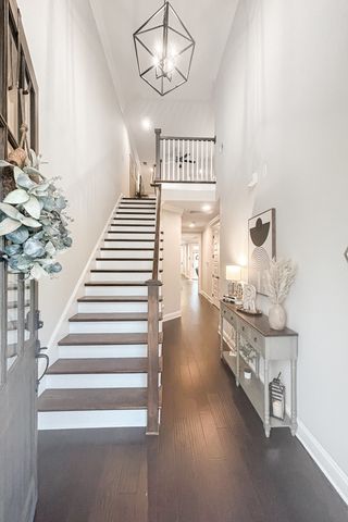 a view of entryway and hall with wooden floor