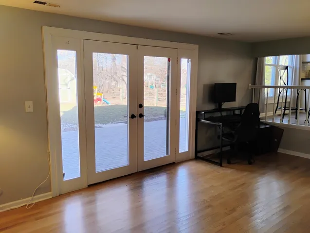 a view of a livingroom with hardwood floor and a window