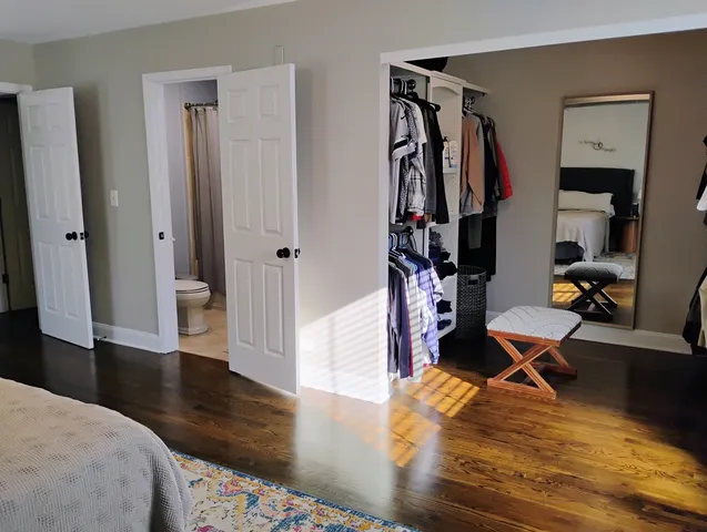 a room with wooden floor and gym equipment