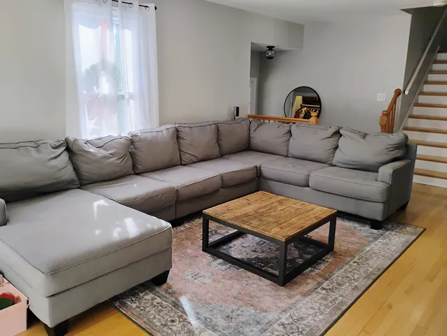 a living room with furniture and a rug
