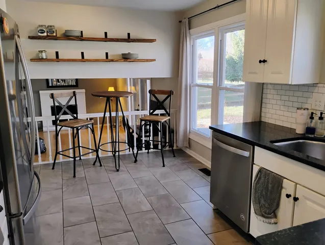 a kitchen with stainless steel appliances granite countertop a sink and a stove