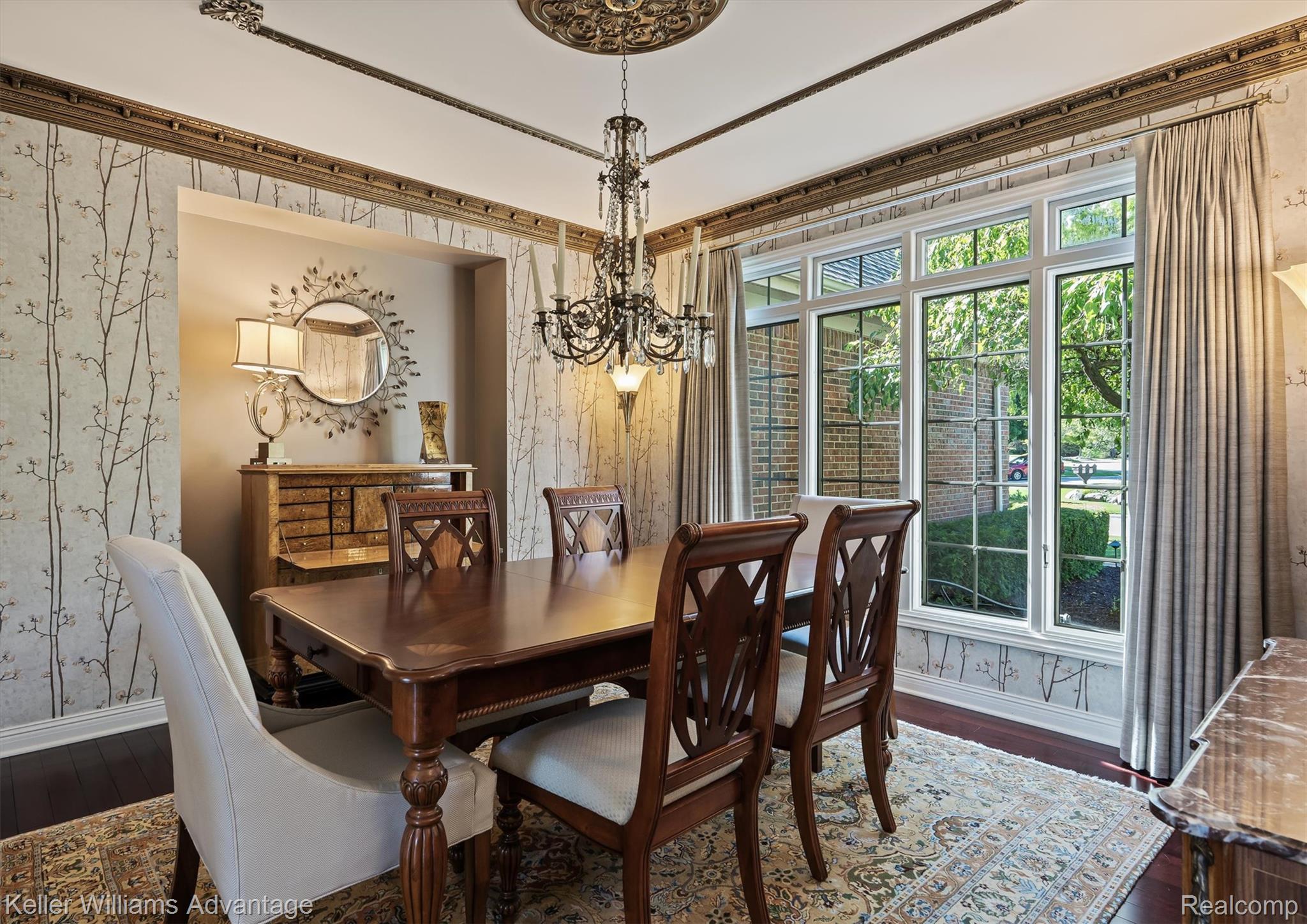 22878 Tree Top Court South Lyon, MI 48178 - Photo 13 of 75 Formal dining area featuring hardwood flooring, intricate crown molding, a decorative ceiling medallion, and a chandelier with candle-style lights