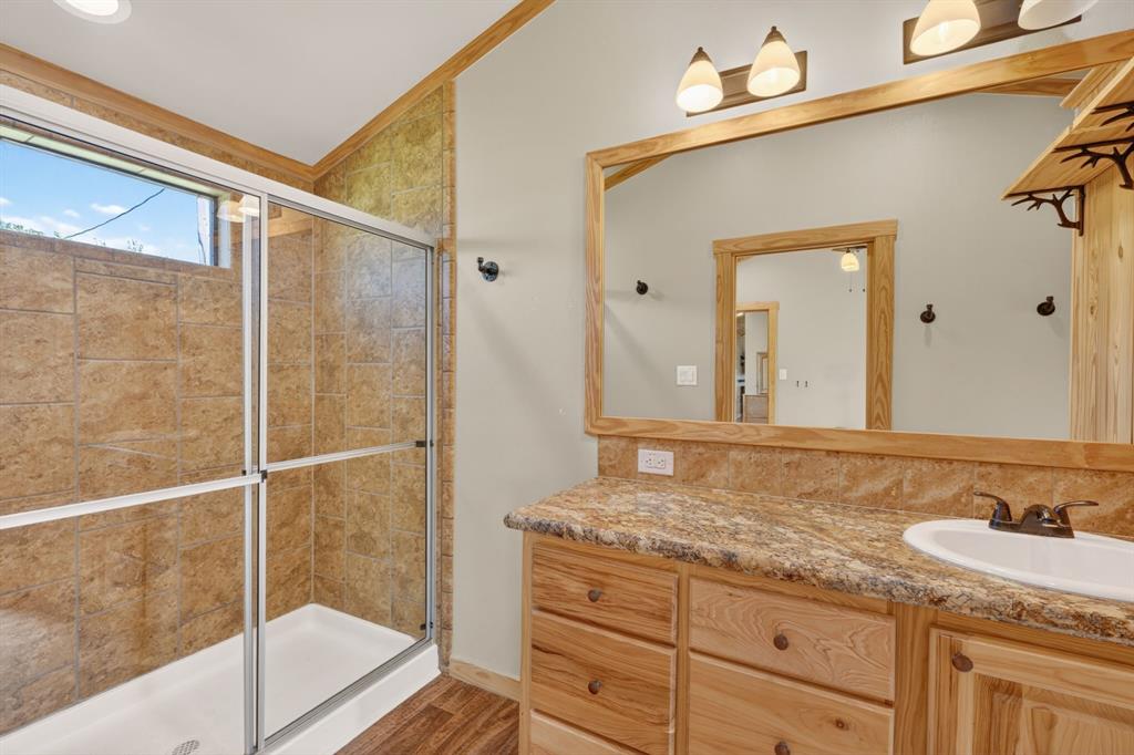 2401 Lamkin Road Mineral Wells, TX 76067 - Photo 20 of 36 a bathroom with a granite countertop sink mirror and shower