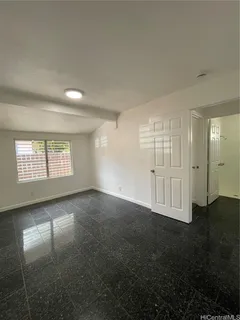 an empty room with windows and closet area