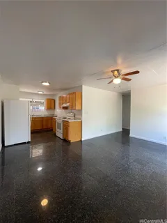 a view of a livingroom with furniture and kitchen view
