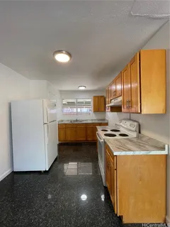 a kitchen with stainless steel appliances granite countertop a stove a sink and a refrigerator with wooden floor