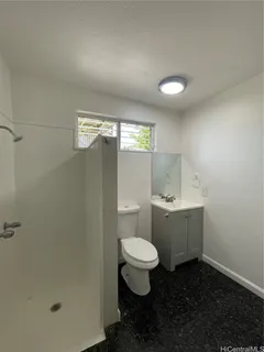 a bathroom with a toilet sink and shower