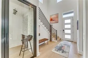 a view of entryway and hall with wooden floor