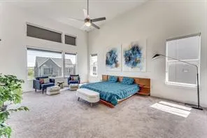 a bedroom with furniture and a large window