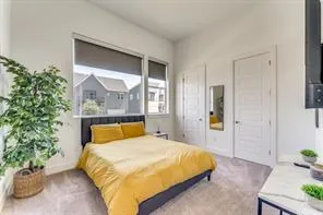 a bedroom with a bed and a potted plant