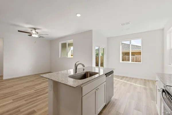 a kitchen with a sink and chandelier