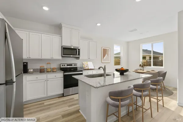 a kitchen with sink a stove and chairs