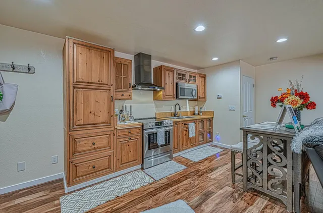 a bathroom with a granite countertop sink mirror vanity and a bathtub