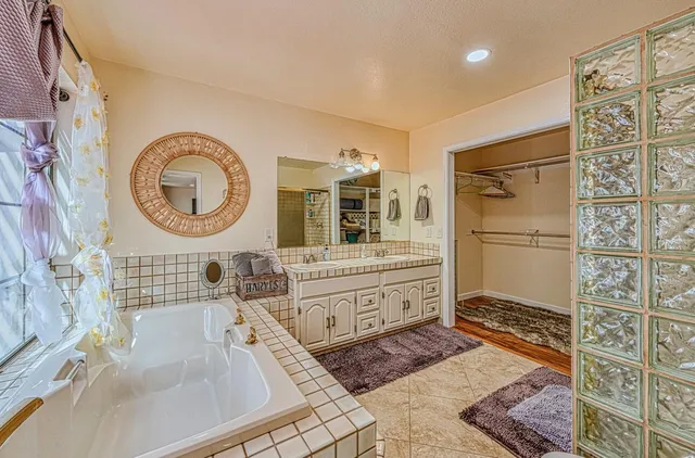 a balcony with wooden floor barbeque oven and outdoor seating