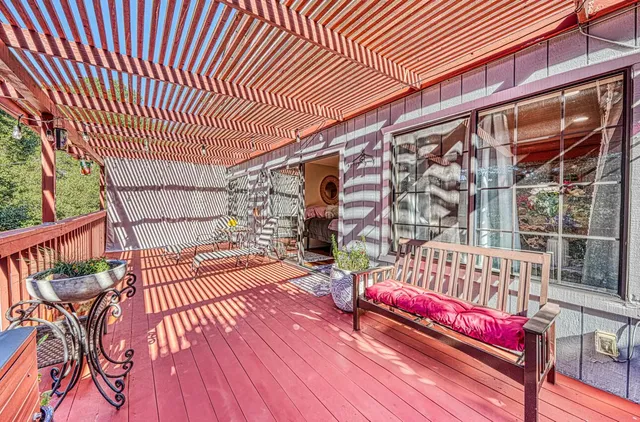 a view of a house with backyard and sitting area