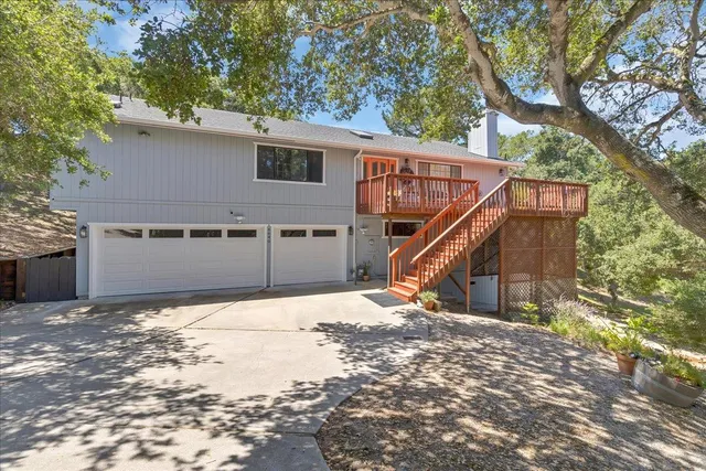 a balcony with wooden floor and outdoor seating